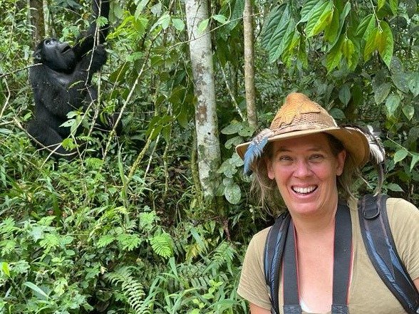 Hollie M'gog with mountain gorilla behind